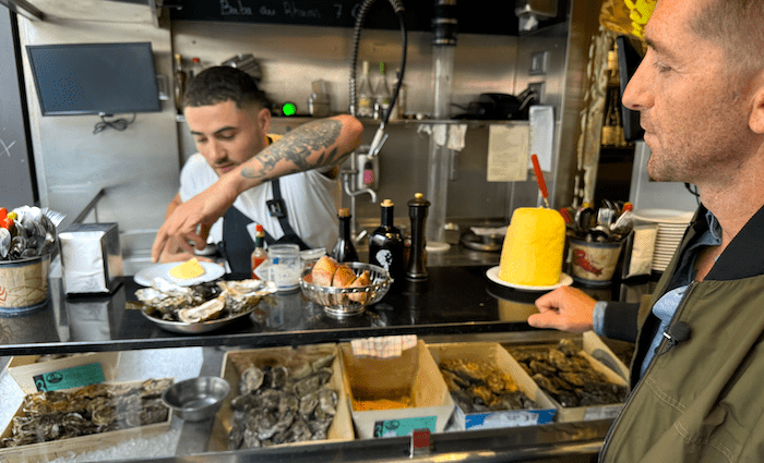 Sean P Finelli from The Tour Guy eating oysters at L'avant Comptoir de la mer in Paris Saint Germaine
