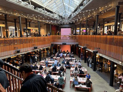 People walking around a large hall.