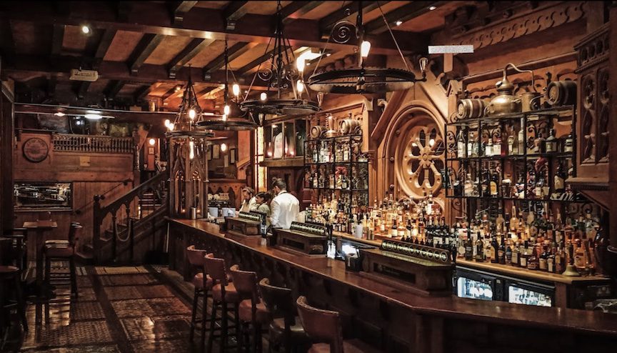 Leather seats next to a wooden bar at Waxy O'Connor's in London.