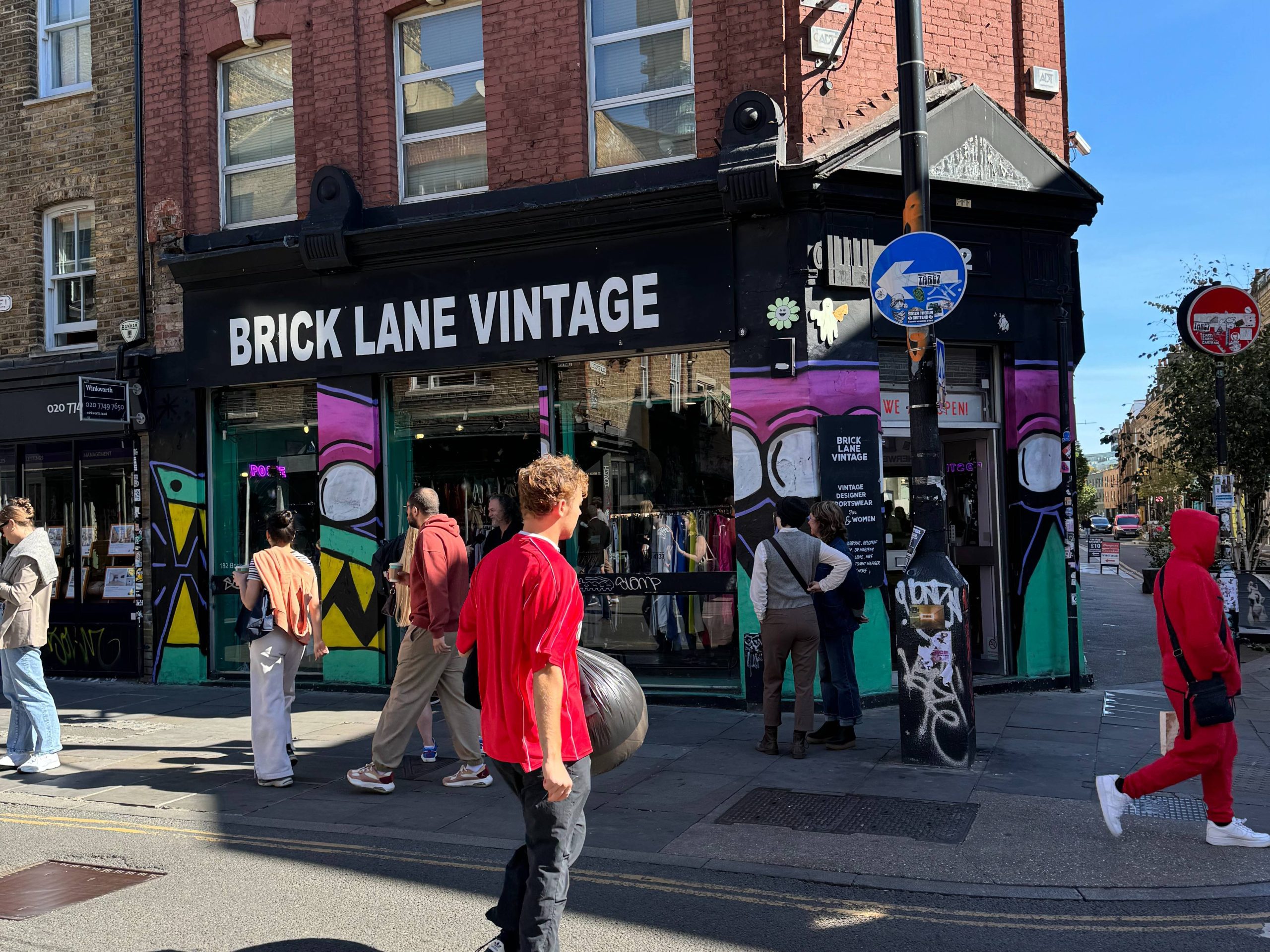 Black building with a white sign that says "Black Lane Vintage'