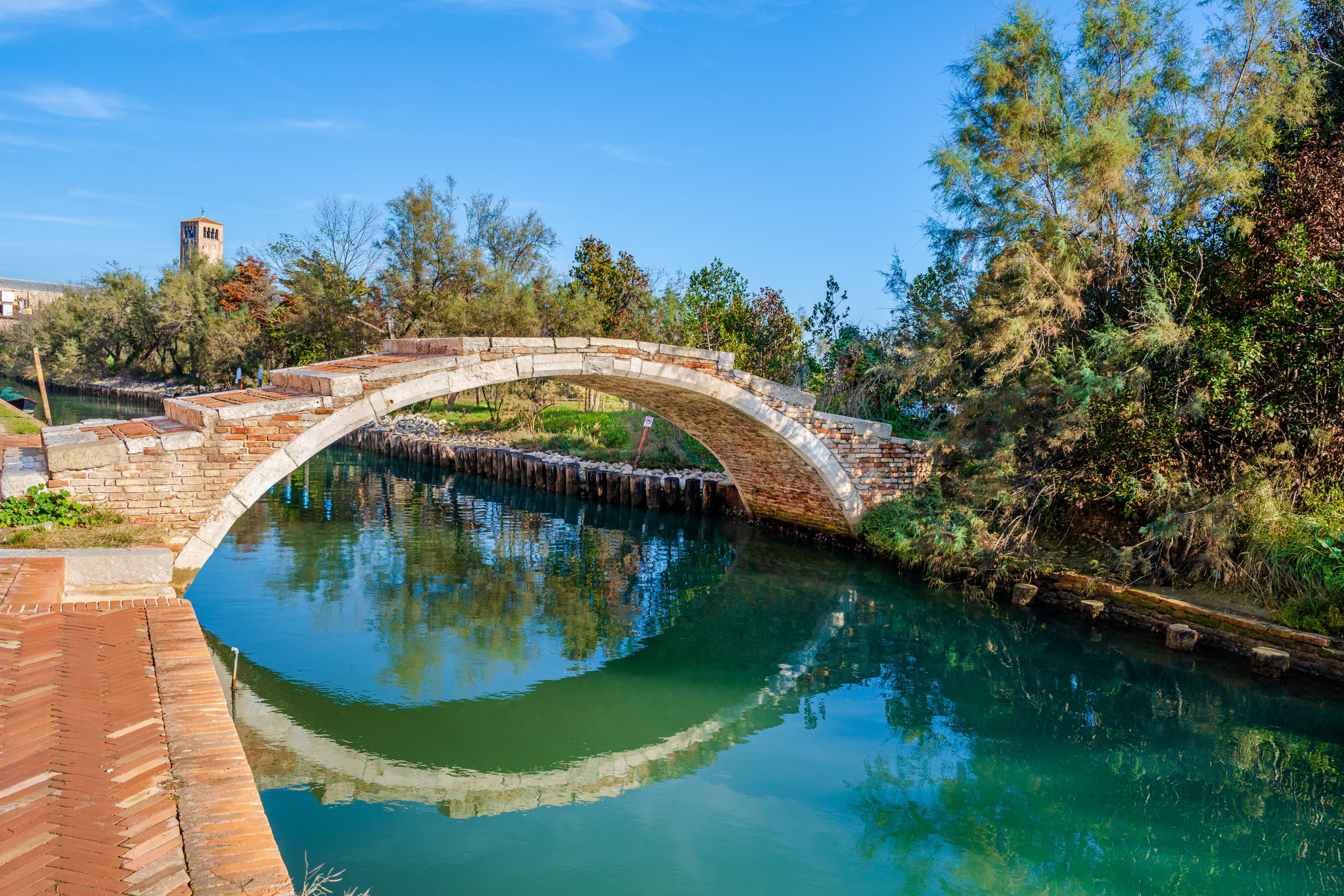 A stone bridge over a canal in Venice, Italy.