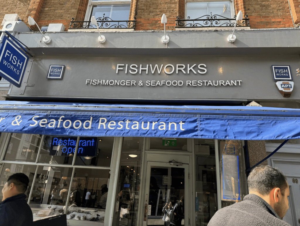 Grey building with a blue sign that reads "FishWorks"