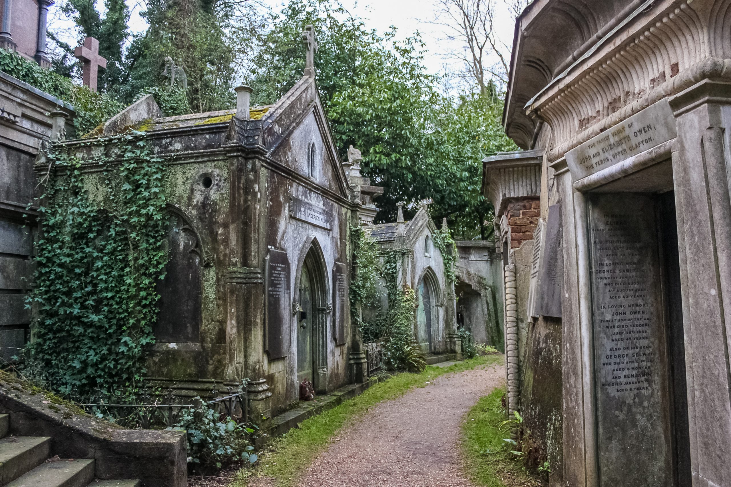 Large stone mausoleum in a cemetery.