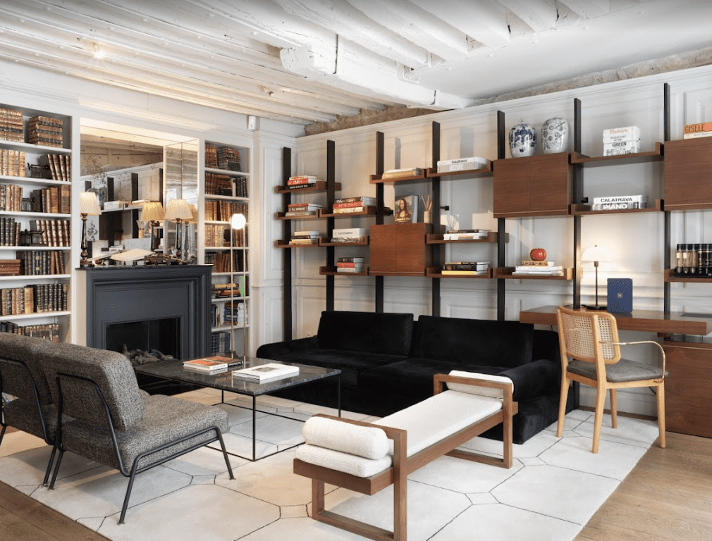 A Black fireplace surrounded by a book shelf filled with books.