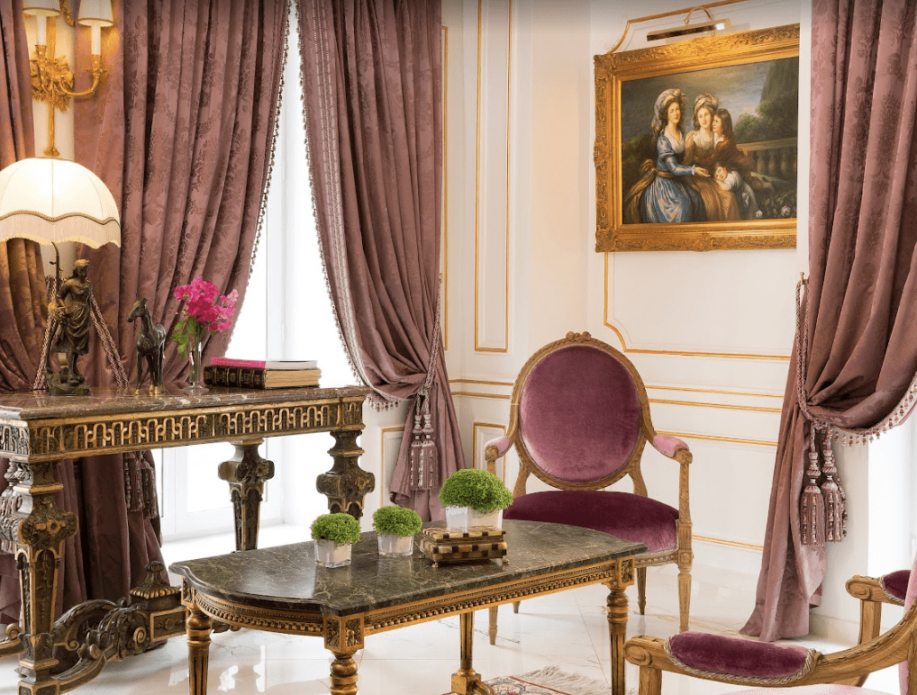 Purple velvet curtains and chairs with marble tables.