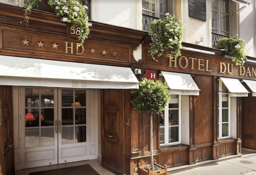 Wooden building with white awnings.