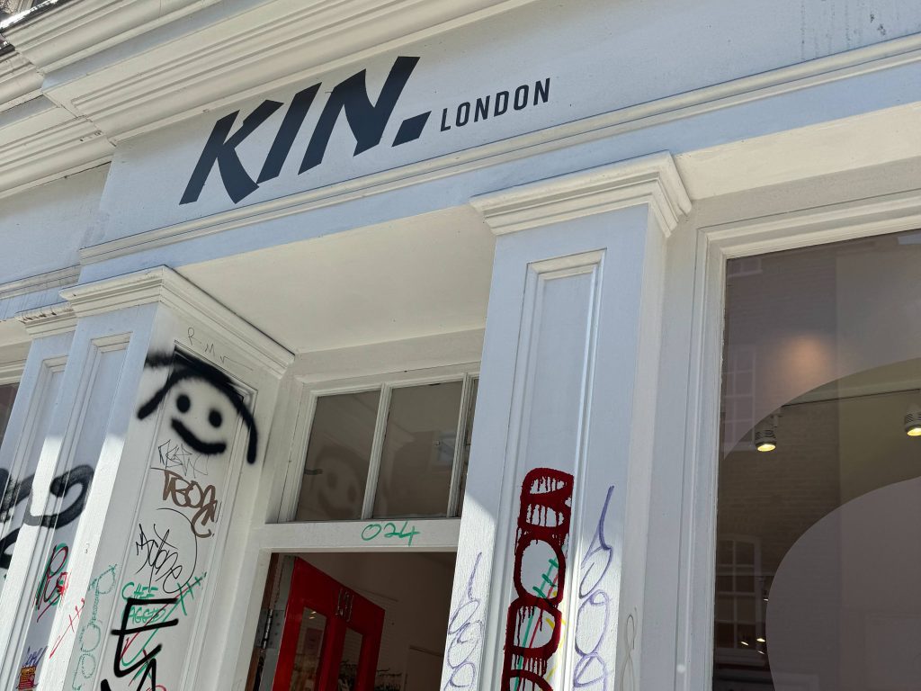 White building with black font that reads "Kin"