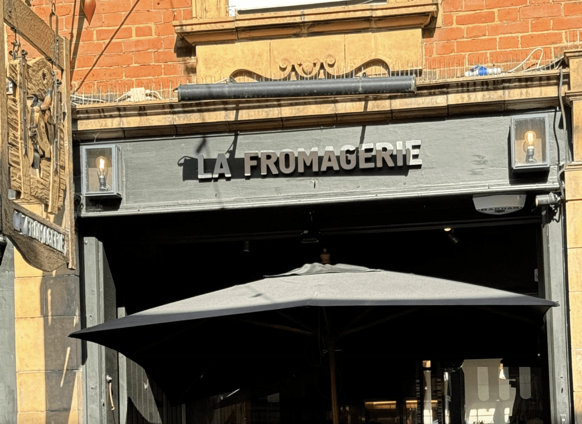 Grey storefront with a sign that reads "La Fromagerie"