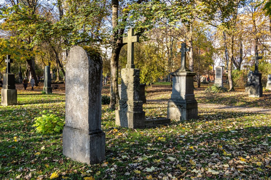 Gravestones with crosses stand in a line. 