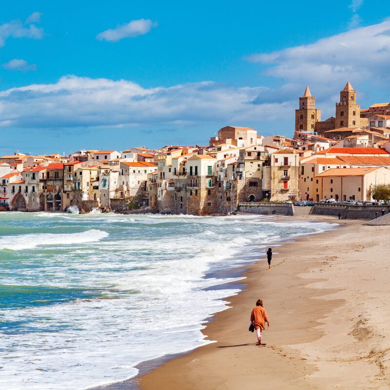 walking along the bech of Cefalu, Sicily