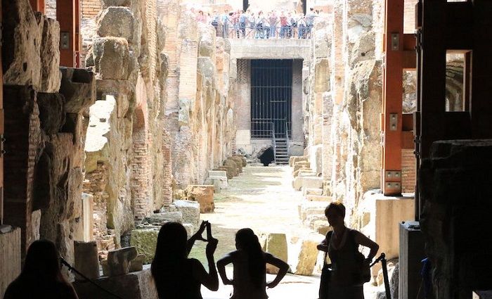 people taking photo of the underground at colosseum