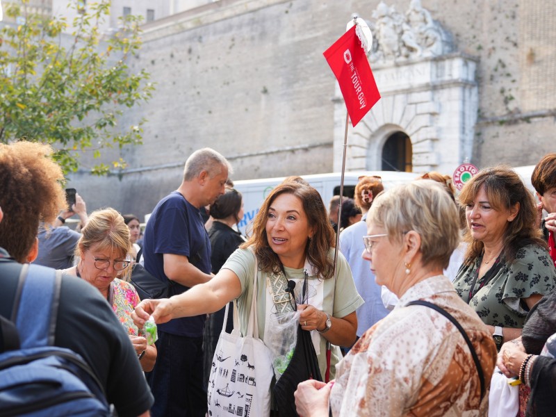 woman tour guide handing out skip-the-line vatican tickets