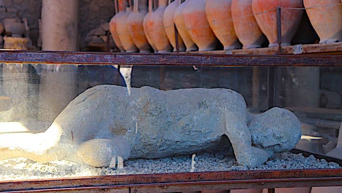 Plaster cast of a person laying on their side killed in the volcanic eruption that destroyed Pompeii. 